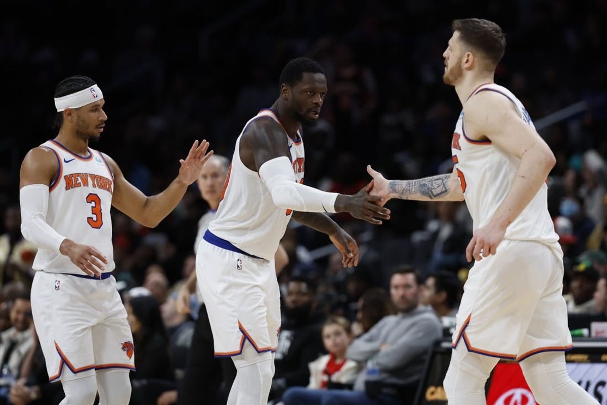 Jan 6, 2024; Washington, District of Columbia, USA; New York Knicks forward Julius Randle (30) celebrates on the court with Knicks center Isaiah Hartenstein (55) and Knicks guard Josh Hart (3) against the Washington Wizards in the fourth quarter at Capital One Arena.