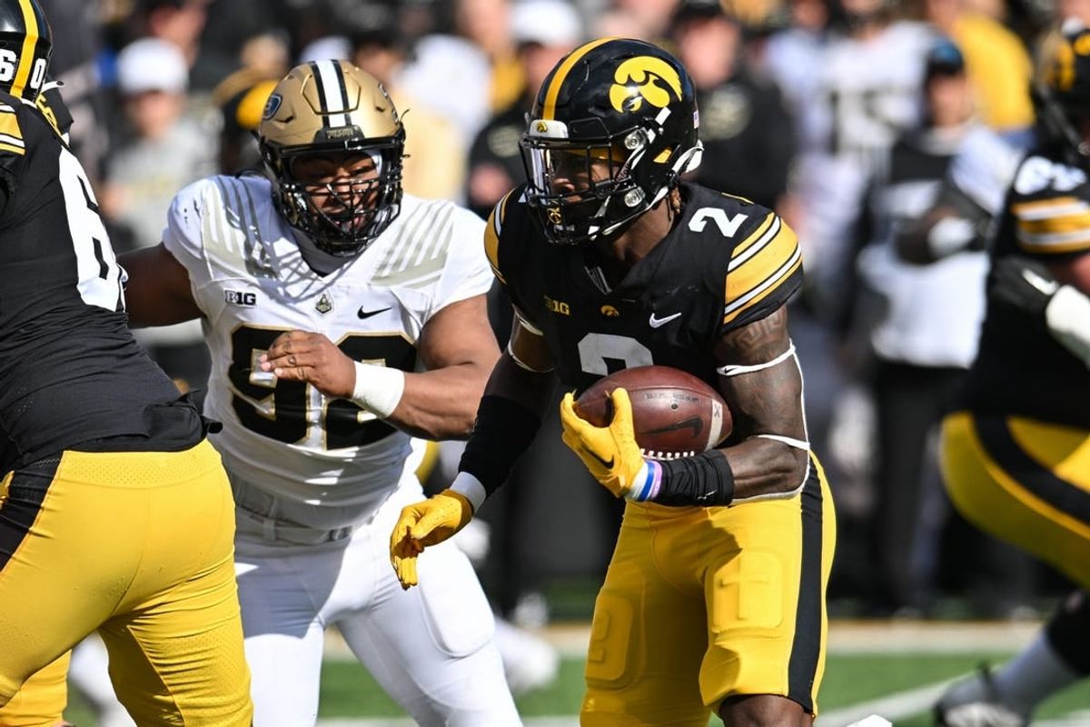 Oct 7, 2023; Iowa City, Iowa, USA; Iowa Hawkeyes running back Kaleb Johnson (2) runs the ball as Purdue Boilermakers defensive lineman Mo Omonode (92) pursues during the first quarter at Kinnick Stadium.
