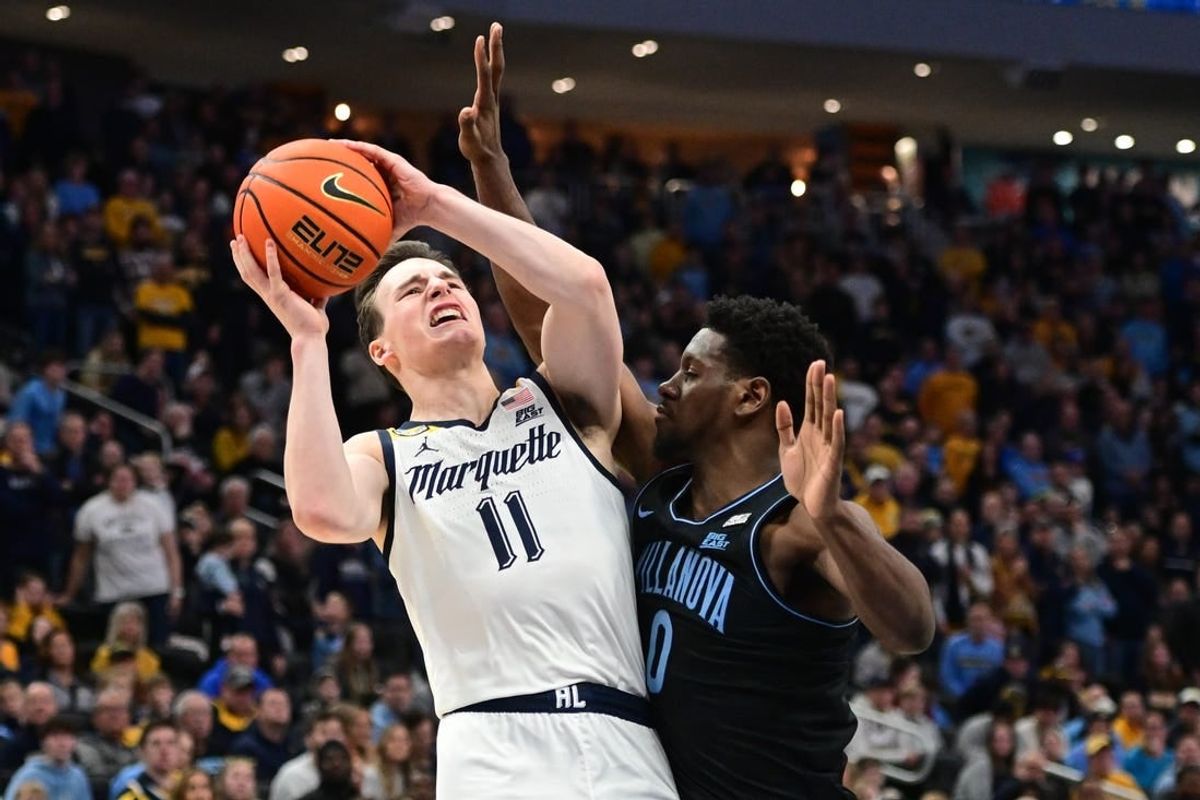 Jan 15, 2024; Milwaukee, Wisconsin, USA; Marquette Golden Eagles guard Tyler Kolek (11) takes a shot against Villanova Wildcats guard TJ Bamba (0) in the second half at Fiserv Forum.