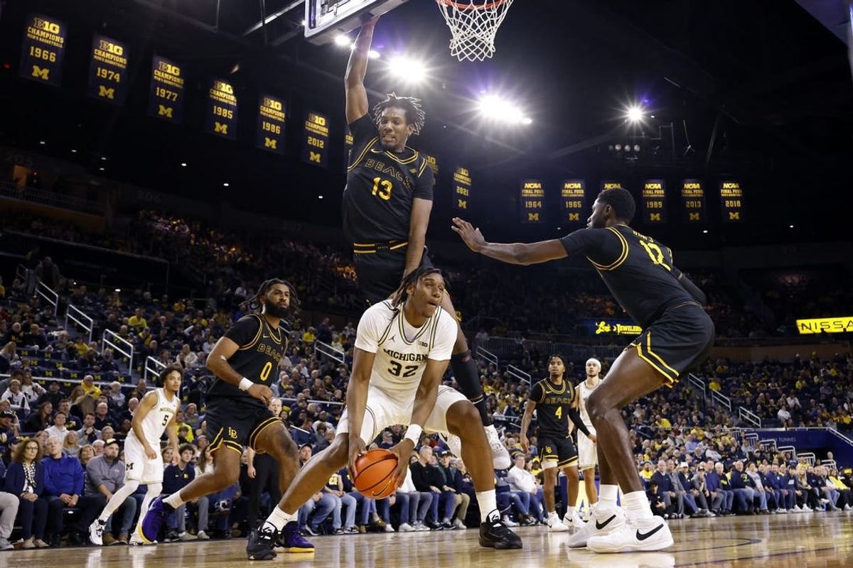 Nov 17, 2023; Ann Arbor, Michigan, USA;  Michigan Wolverines forward Tarris Reed Jr. (32) is defended by Long Beach State 49ers center Chayce Polynice (13) in the first half at Crisler Center.