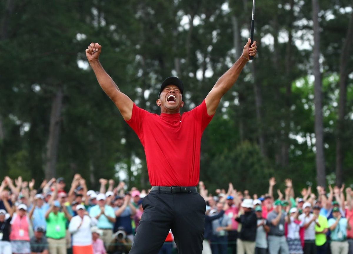 Tiger Woods celebrates after making a putt on the 18th green to win The Masters golf tournament at Augusta National Golf Club on April 14, 2019.