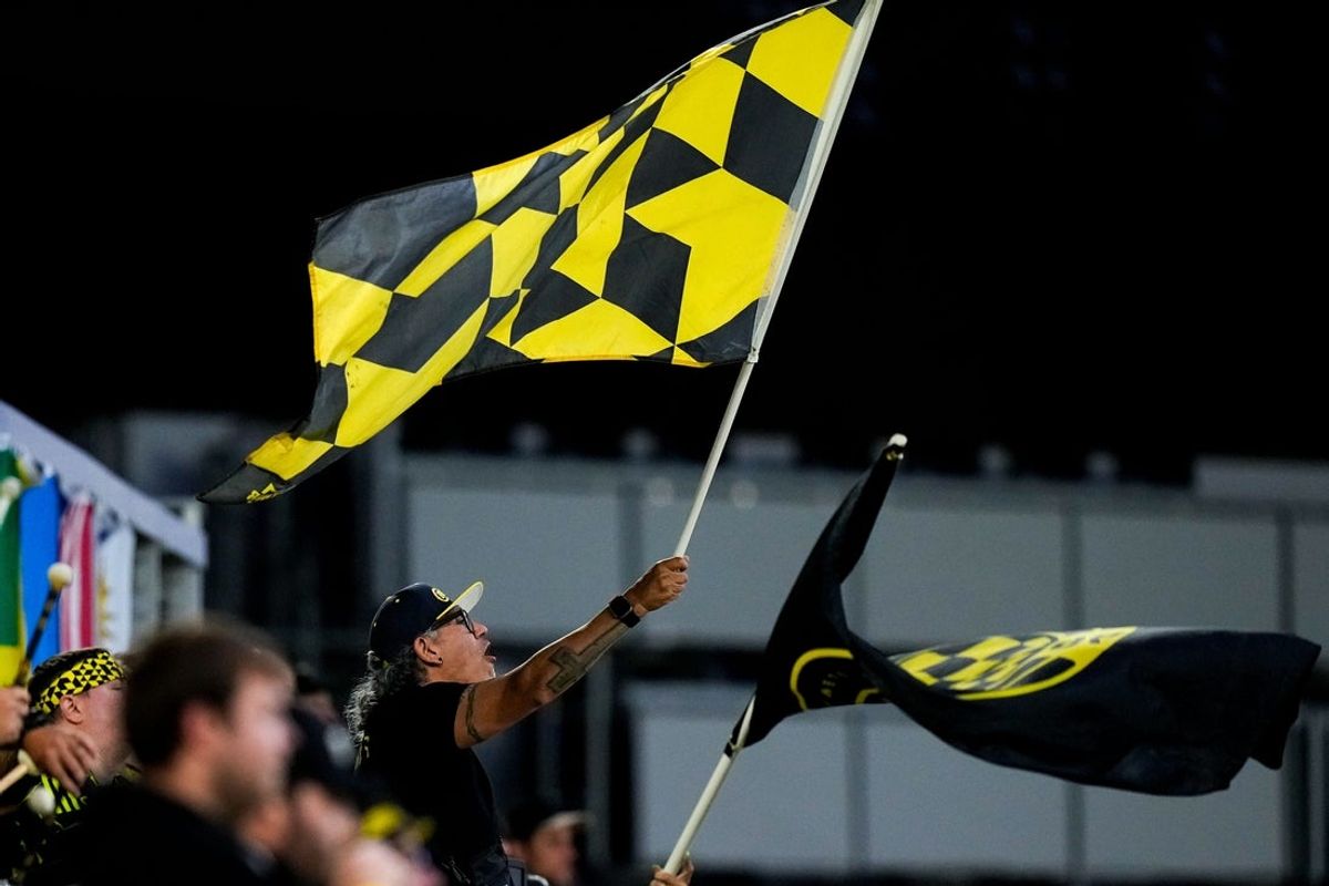 Columbus Crew fan waves a flag in the first half of the U.S. Open Cup quarterfinal match at ScottsMiracle-Gro Field on Wednesday, May 20, 2026 in Columbus, Ohio.
