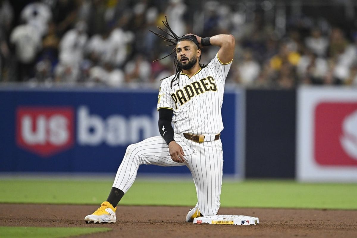 May 20, 2026; San Diego, California, USA; San Diego Padres second baseman Fernando Tatis Jr. (23) kneels on second base after being forced out during the eighth inning against the Los Angeles Dodgers at Petco Park. Mandatory Credit: Denis Poroy-Imagn Images