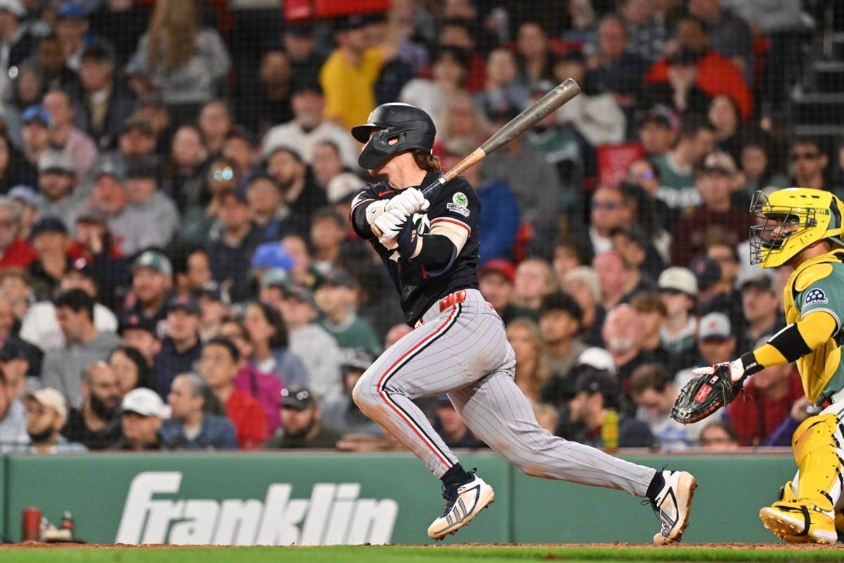 May 22, 2026; Boston, Massachusetts, USA; Minnesota Twins shortstop Orlando Arcia (11) hits a single against the Boston Red Sox during the seventh inning at Fenway Park. Mandatory Credit: Eric Canha-Imagn Images