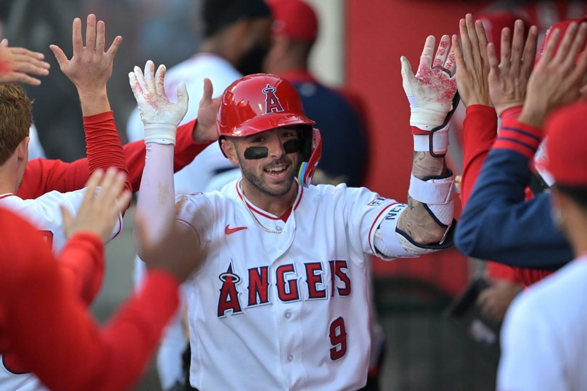 May 22, 2026; Anaheim, California, USA;  Los Angeles Angels shortstop Zach Neto (9) is congratulated in the dugout after hitting a leadoff solo home run during the first inning against the Texas Rangers at Angel Stadium. Mandatory Credit: Jayne Kamin-Oncea-Imagn Images
