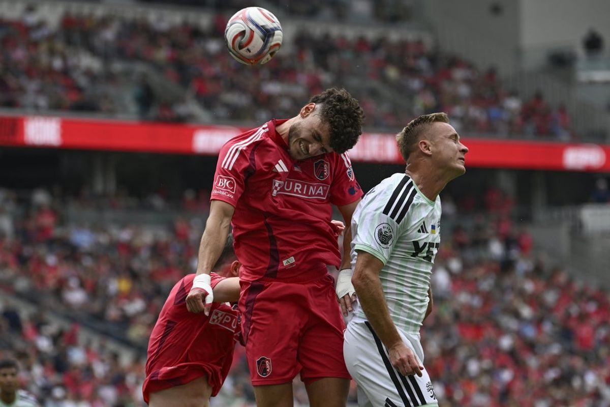 May 23, 2026; St. Louis, Missouri, USA; St. Louis CITY SC midfielder Dante Polvara (21) and Austin FC defender Oleksandr Svatok (5) of up for a header in the first half at Energizer Park. Mandatory Credit: Joe Puetz-Imagn Images