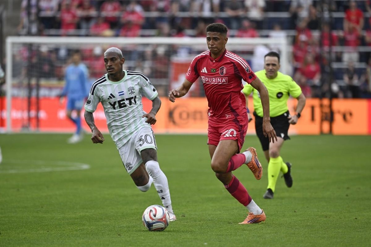 May 23, 2026; St. Louis, Missouri, USA; Austin FC midfielder Joseph Rosales (30) pressures St. Louis CITY SC defender Rafael Santos (20) in the second half at Energizer Park. Mandatory Credit: Joe Puetz-Imagn Images
