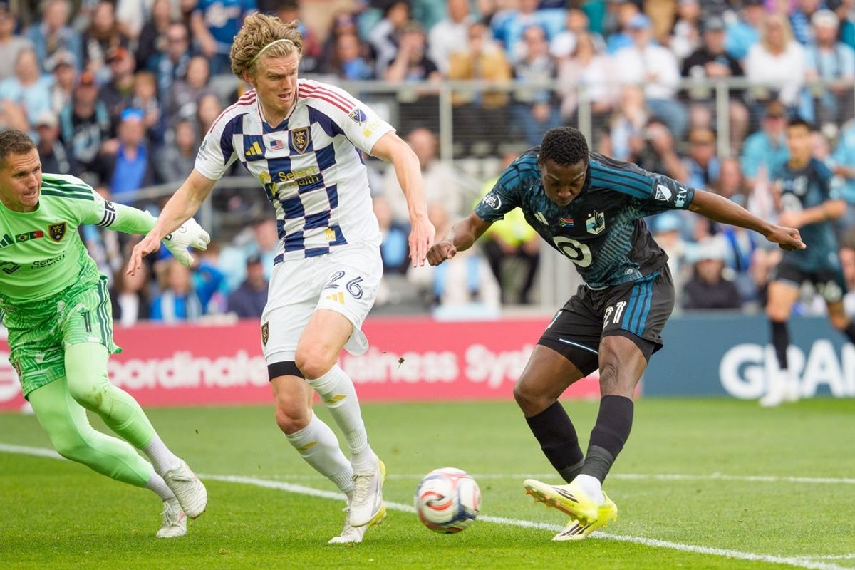 May 23, 2026; Saint Paul, Minnesota, USA; Minnesota United FC forward Bongokuhle Hlongwane (21) shoots by the defense of Real Salt Lake defender Philip Quinton (26) defends in the second half at Allianz Field. Mandatory Credit: Matt Blewett-Imagn Images