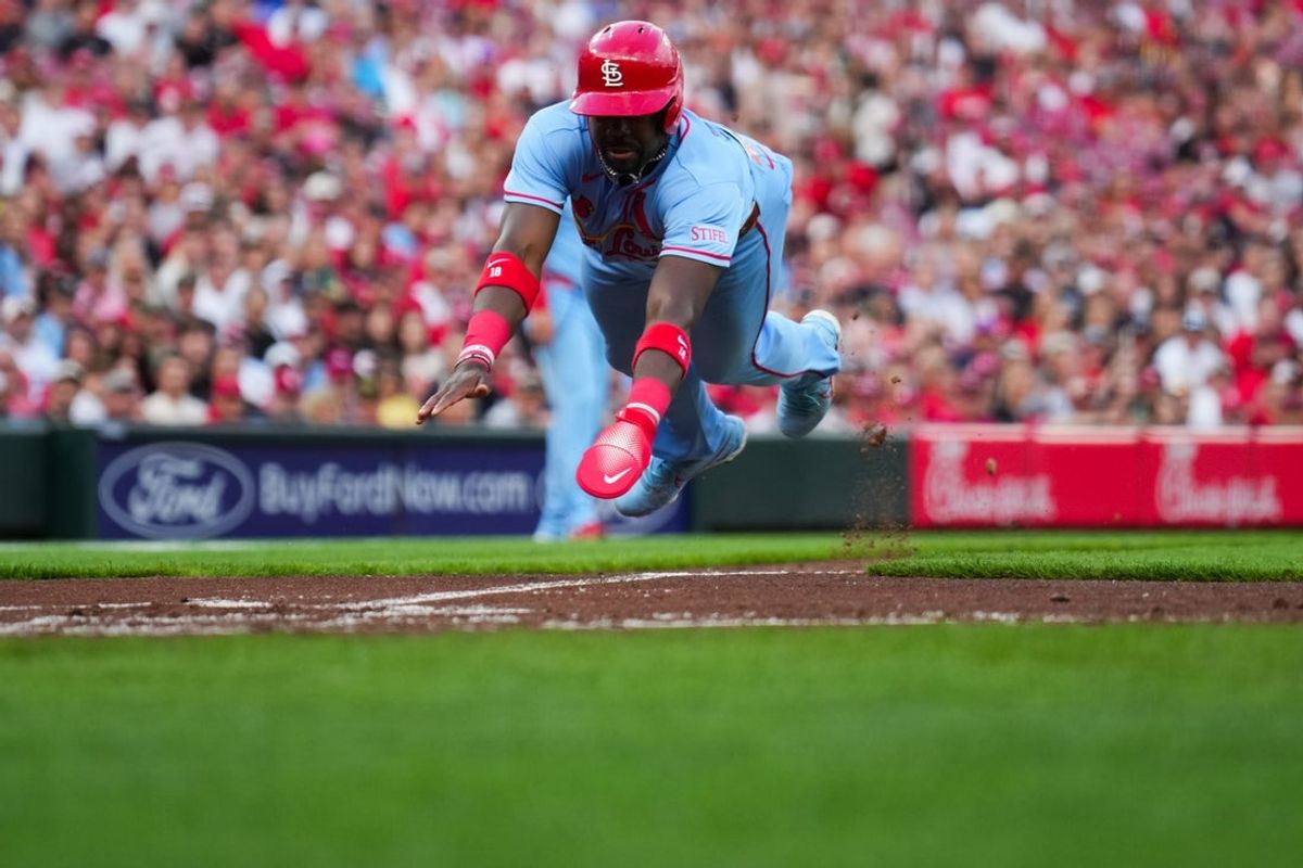 May 23, 2026; Cincinnati, Ohio, USA;  St. Louis Cardinals outfielder Jordan Walker (18) scores a run on a sacrifice fly by shortstop Masyn Winn (0), during the game against the Cincinnati Reds in the second inning at Great American Ball Park. Mandatory Credit: Aaron Doster-Imagn Images