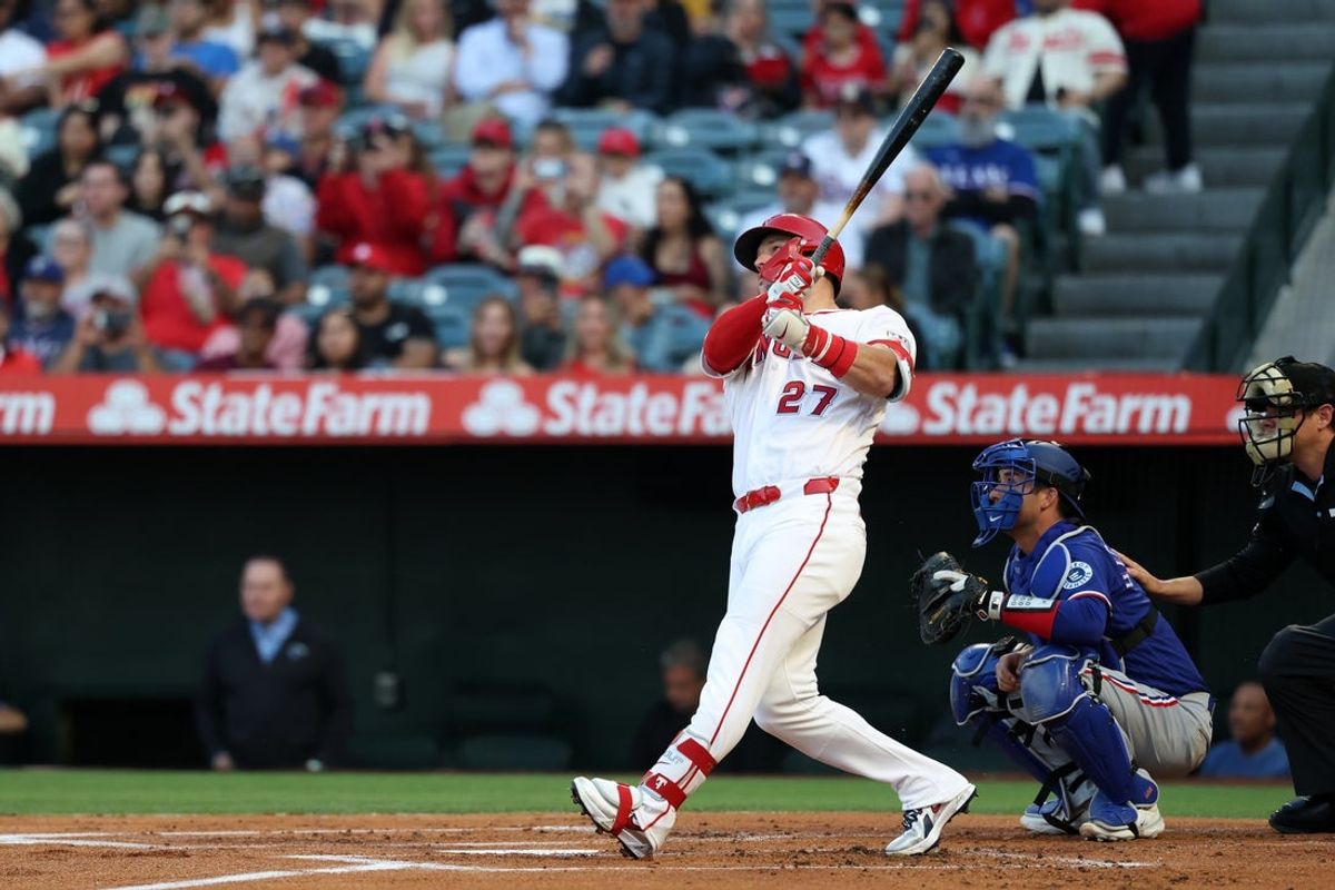 May 23, 2026; Anaheim, California, USA;  Los Angeles Angels center fielder Mike Trout (27) hits a two-run home run during the first inning against the Texas Rangers at Angel Stadium. Mandatory Credit: Kiyoshi Mio-Imagn Images