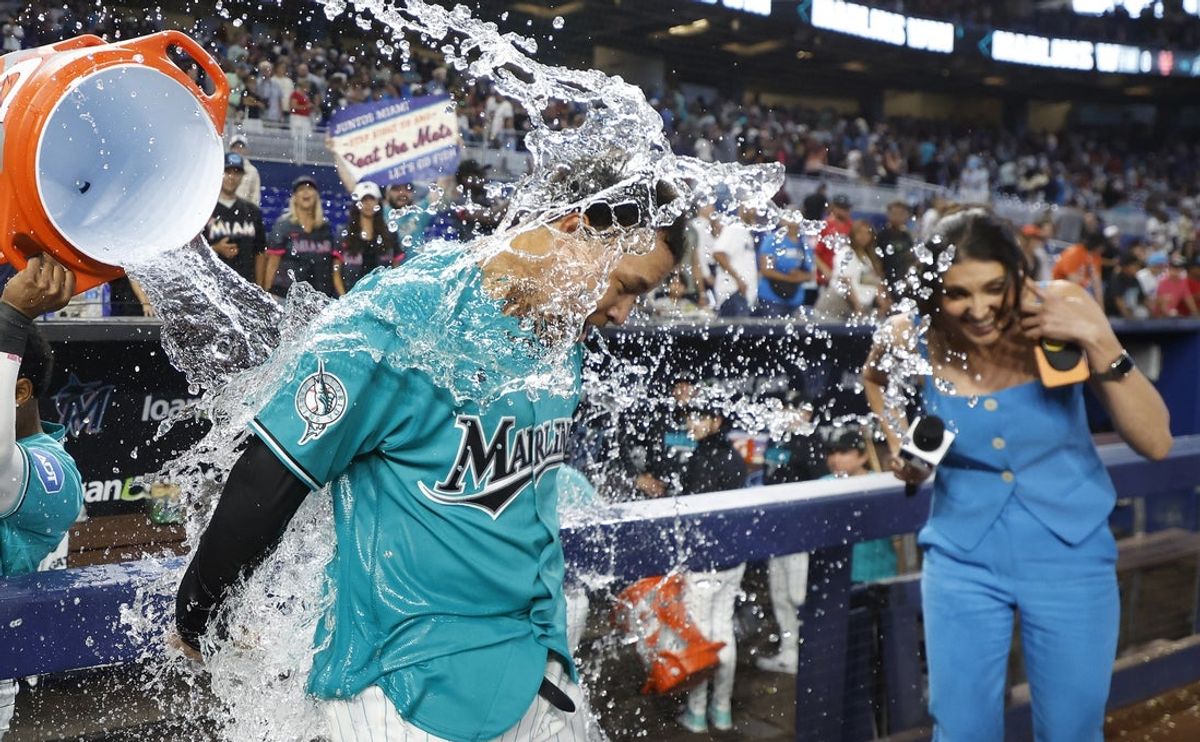 May 24, 2026; Miami, Florida, USA;  Miami Marlins pinch hitter Heriberto Hernandez (13) gets doused after hitting a grand slam to end the game against the New York Mets at loanDepot Park. Mandatory Credit: Rhona Wise-Imagn Images