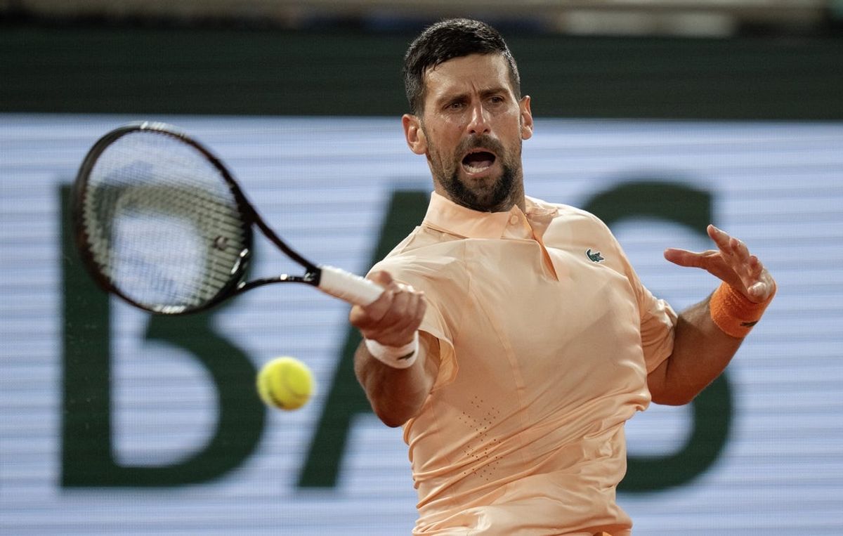 May 24, 2026; Paris, France;  Novak Djokovic of Serbia returns a shot in his first round match against Giovanni Mpetshi Perricard of France on day one at Stade Roland Garros. Mandatory Credit: Susan Mullane-Imagn Images