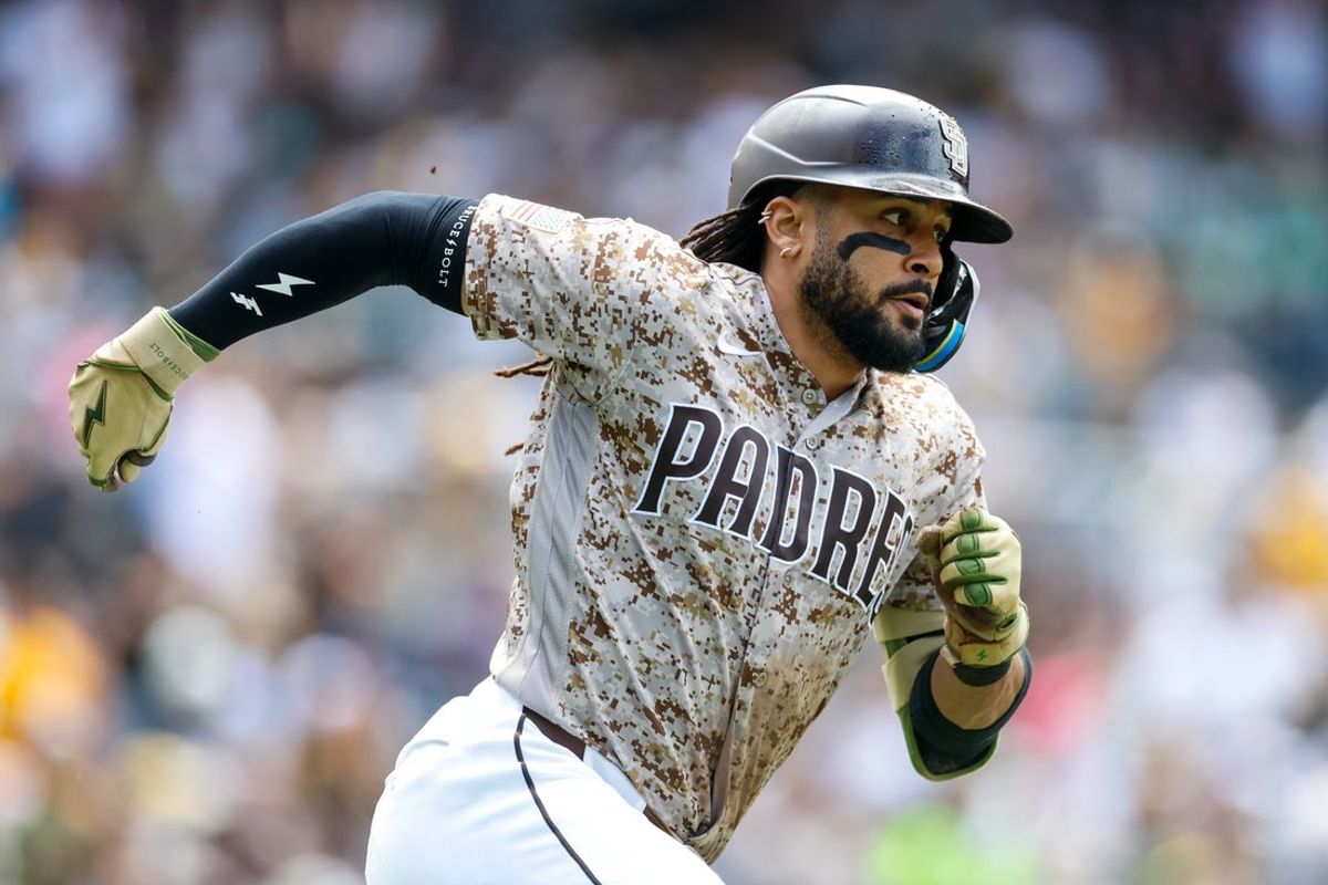 May 24, 2026; San Diego, California, USA; San Diego Padres second baseman Fernando Tatis Jr. (23) hits a double during the fifth inning against the Athletics at Petco Park. Mandatory Credit: David Frerker-Imagn Images