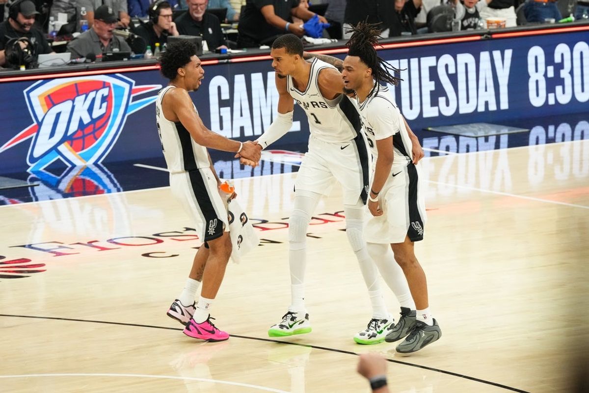 May 24, 2026; San Antonio, Texas, USA; San Antonio Spurs forward Keldon Johnson (3), center Victor Wembanyama (1) and guard Stephon Castle (5) react after  the second quarter against the Oklahoma City Thunder  during game four of the western conference finals for the 2026 NBA playoffs at Frost Bank Center. Mandatory Credit: Scott Wachter-Imagn Images