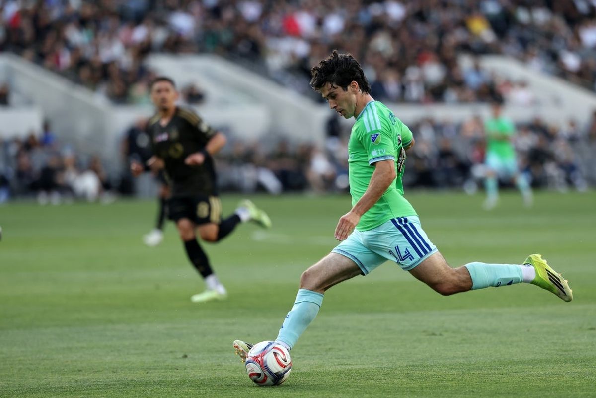 May 24, 2026; Los Angeles, California, USA;  Seattle Sounders FC forward Paul Rothrock (14) kicks the ball during the first half against LAFC at BMO Stadium. Mandatory Credit: Kiyoshi Mio-Imagn Images