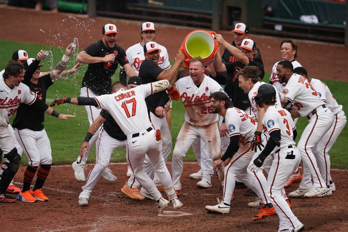 May 25, 2026; Baltimore, Maryland, USA; Baltimore Orioles outfielder Colton Cowser (17) celebrates with teammates at home plate after hitting the game-winning two run home run against Tampa Bay Rays pitcher Jesse Scholtens (not pictured) during the thirteenth inning at Oriole Park at Camden Yards. Mandatory Credit: Mitch Stringer-Imagn Images