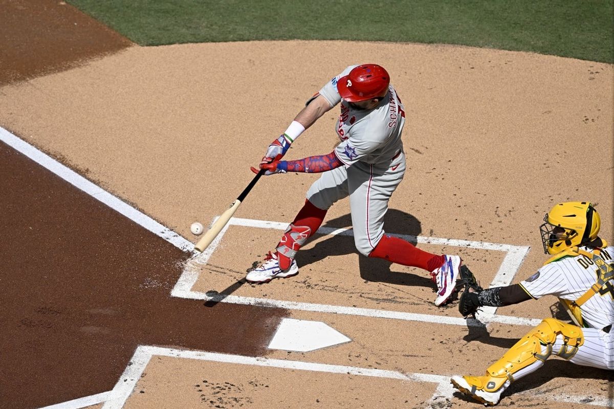 May 25, 2026; San Diego, California, USA; Philadelphia Phillies designated hitter Kyle Schwarber (12) hits a solo home run during the the first inning against the San Diego Padres at Petco Park. Mandatory Credit: Denis Poroy-Imagn Images