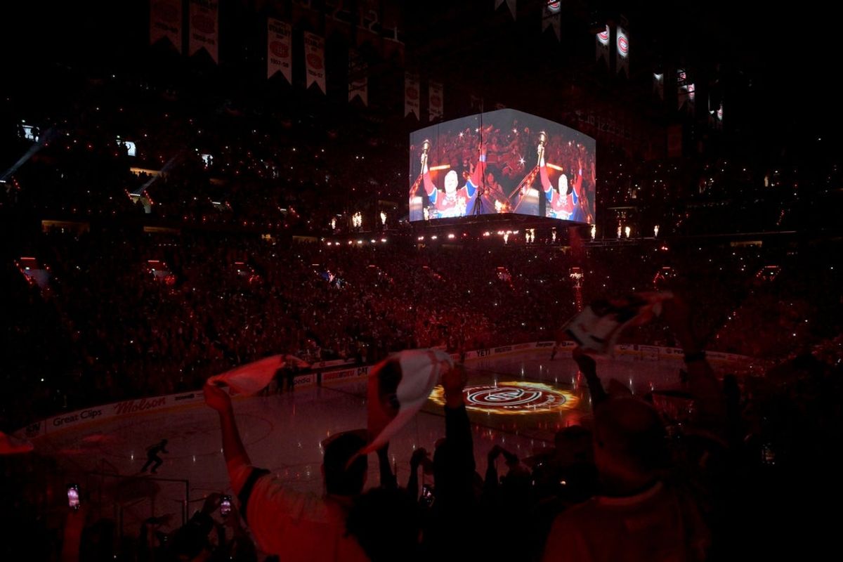 May 25, 2026; Montreal, Quebec, CAN; Former player Claude Lemieux carries the torch before Game 3 of the Eastern Conference Final of the 2026 Stanley Cup Playoffs between the Carolina Hurricanes and Montreal Canadiens at Bell Centre. Mandatory Credit: Eric Bolte-Imagn Images