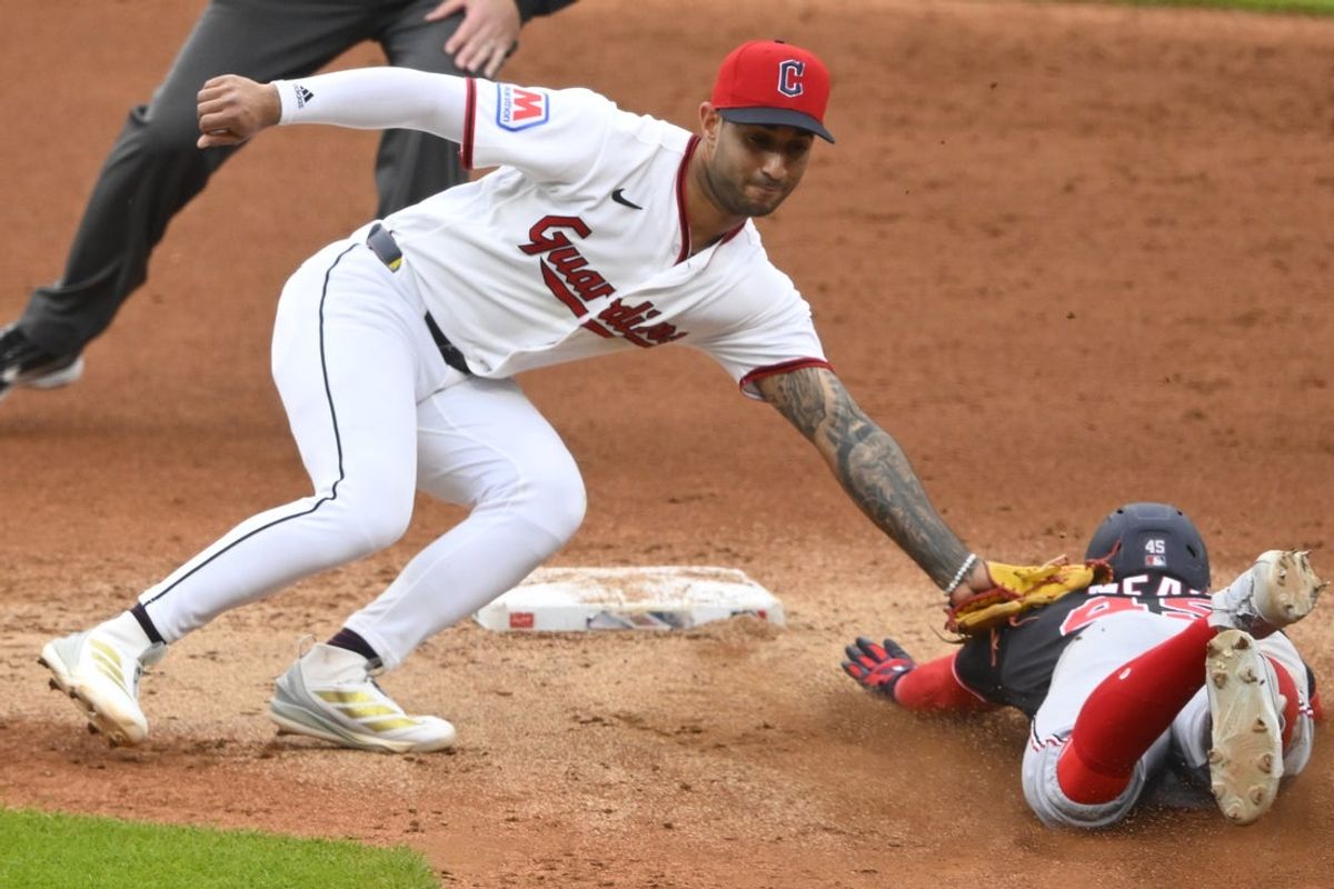 May 26, 2026; Cleveland, Ohio, USA; Washington Nationals third baseman Curtis Mead (45) is tagged out by Cleveland Guardians shortstop Brayan Rocchio (4) while attempting to steal second base in the second inning at Progressive Field. Mandatory Credit: David Richard-Imagn Images
