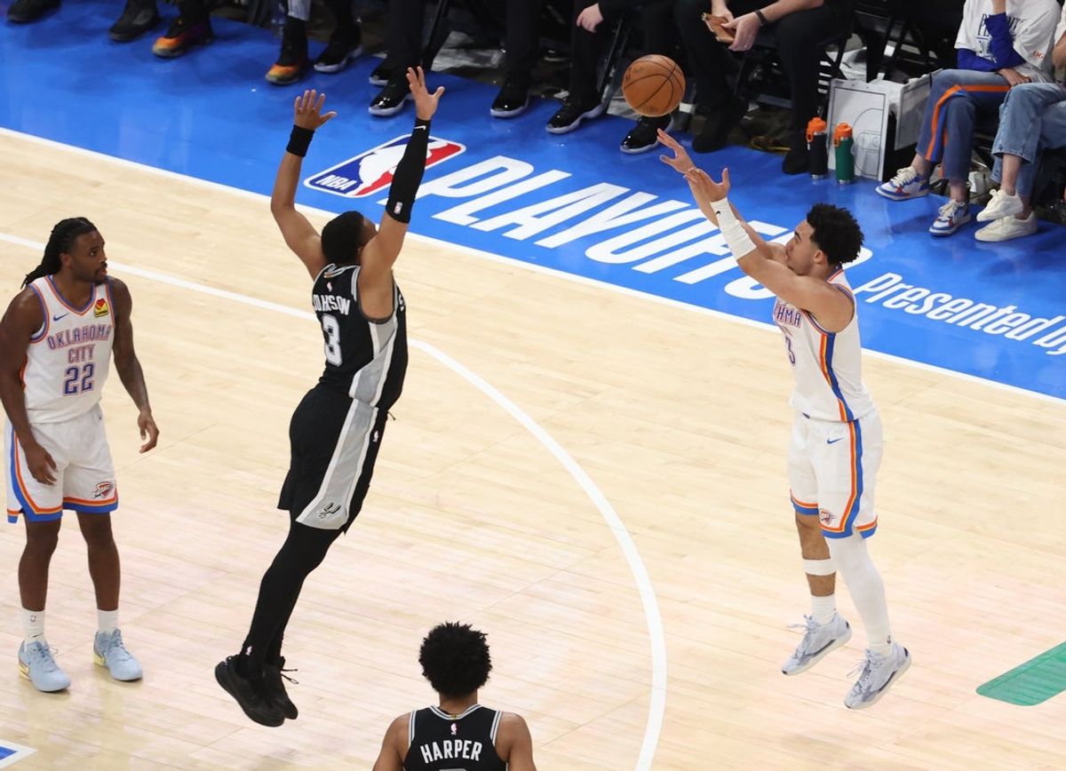 May 26, 2026; Oklahoma City, Oklahoma, USA; Oklahoma City Thunder guard Jared McCain (3) shoots against San Antonio Spurs forward Keldon Johnson (3) during the fourth quarter in game five of the western conference finals for the 2026 NBA playoffs at Paycom Center. Mandatory Credit: Brett Rojo-Imagn Images