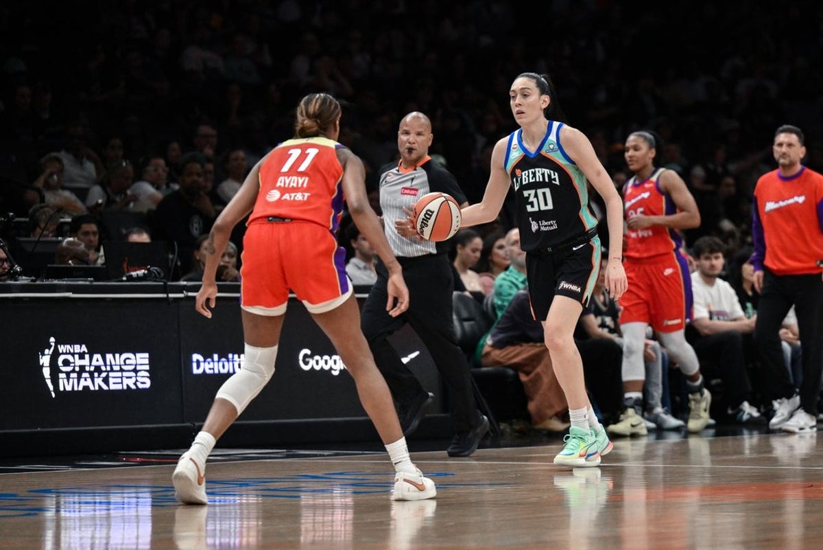May 27, 2026; Brooklyn, New York, USA; New York Liberty forward Breanna Stewart (30) brings the ball up court while defended by  Phoenix Mercury forward Marta Suarez (77) during the first half at Barclays Center. Mandatory Credit: John Jones-Imagn Images