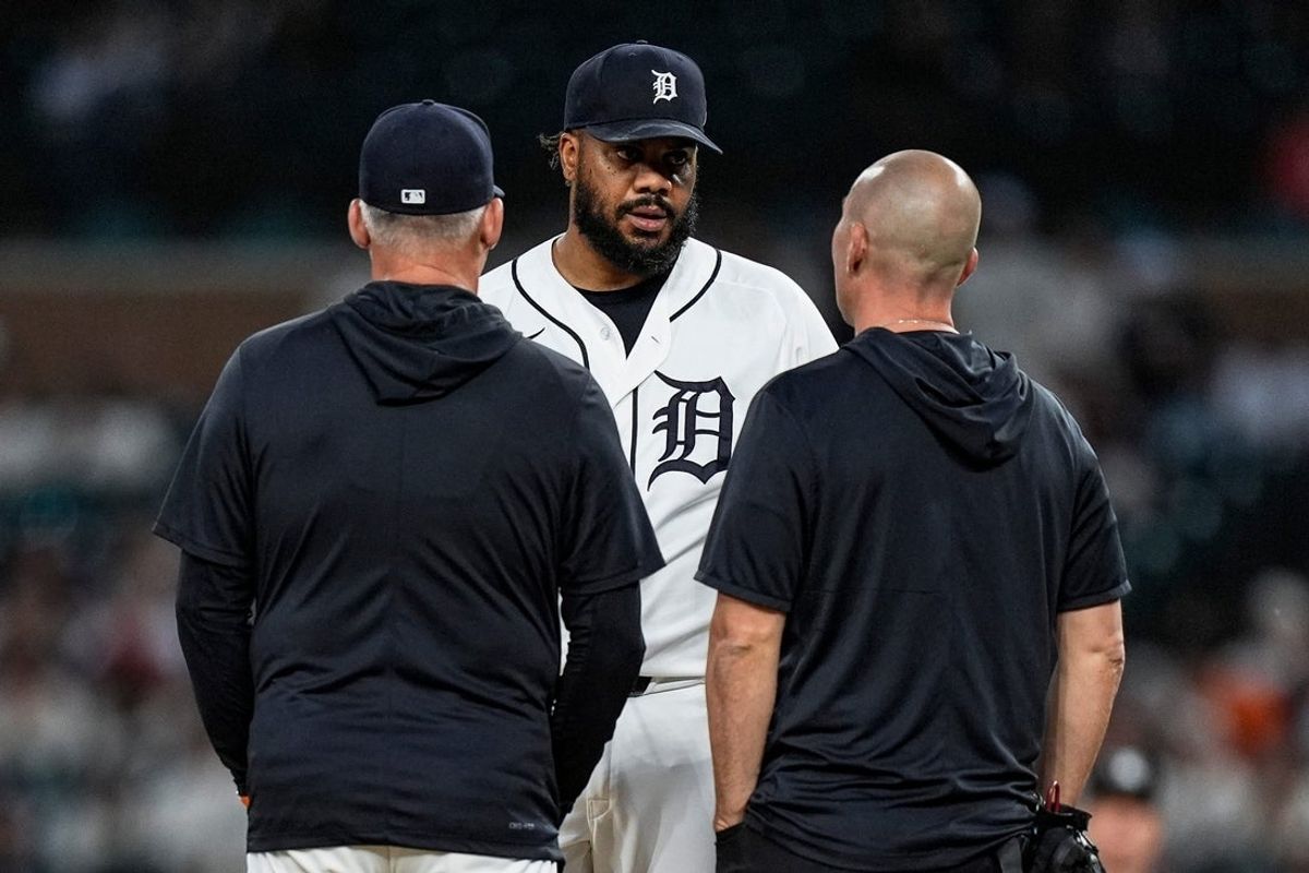 Detroit Tigers pitcher Kenley Jansen (74) talks to manager A.J. Hinch (14), left, and assistant athletic trainer Chris McDonald during the ninth inning against Los Angeles Angels at Comerica Park in Detroit on Wednesday, May 27, 2026.