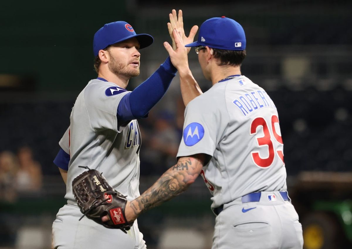 May 27, 2026; Pittsburgh, Pennsylvania, USA;  Chicago Cubs left fielder Ian Happ (8) and relief pitcher Ethan Roberts (39) celebrate after defeating the Pittsburgh Pirates at PNC Park. Mandatory Credit: Charles LeClaire-Imagn Images