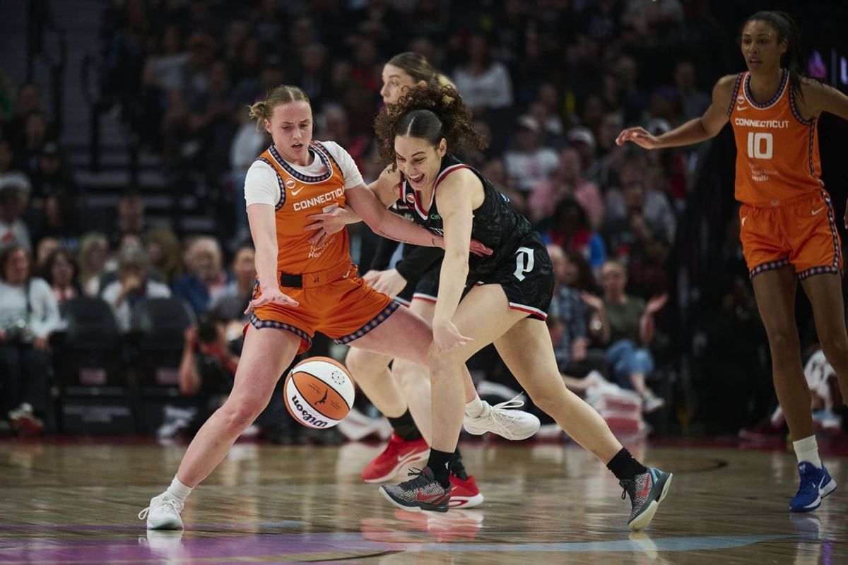 May 27, 2026; Portland, Oregon, USA; Portland Fire guard Carla Leite (0) is fouled during the first half against Connecticut Sun guard Hailey Van Lith (2) at Moda Center. Mandatory Credit: Troy Wayrynen-Imagn Images