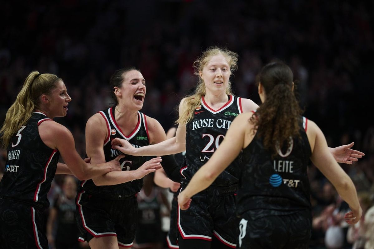 May 27, 2026; Portland, Oregon, USA; Portland Fire forward-center Frieda Buhner (20) celebrates with teammates during the second half after scoring a three point basket against the Connecticut Sun at Moda Center. Mandatory Credit: Troy Wayrynen-Imagn Images