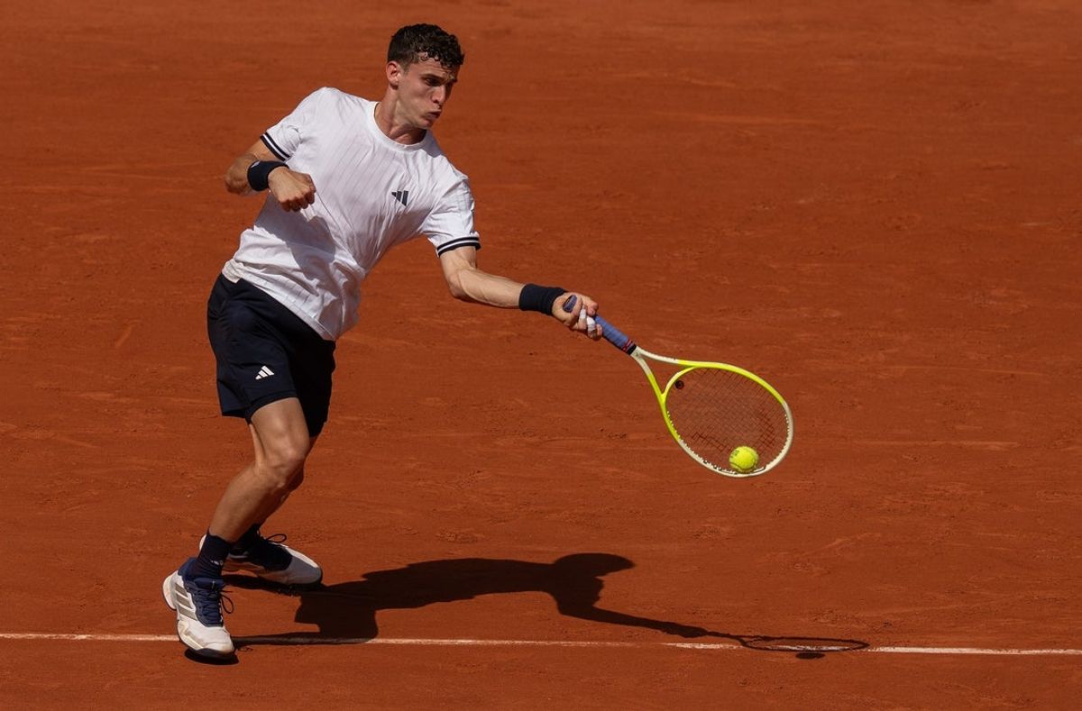 May 28, 2026; Paris, France; Juan Manuel Cerundolo of Argentina returns a shot during his match against Jannik Sinner of Italy on day five at Stade Roland Garros. Mandatory Credit: Susan Mullane-Imagn Images