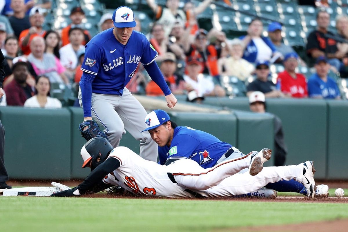 May 28, 2026; Baltimore, Maryland, USA; Baltimore Orioles designated hitter Taylor Ward (3) slides into third base safely past Toronto Blue Jays third baseman Kazuma Okamoto (7) during the first inning at Oriole Park at Camden Yards. Mandatory Credit: Daniel Kucin Jr.-Imagn Images