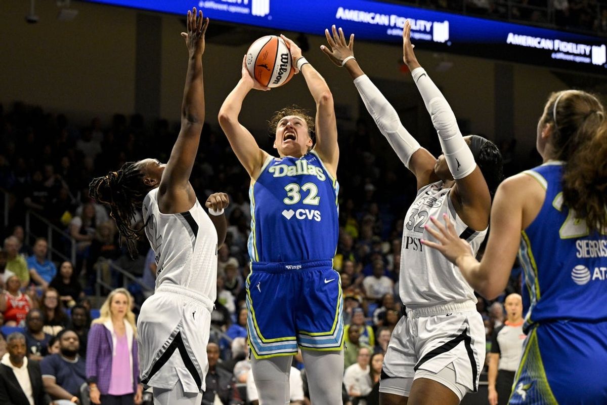 May 28, 2026; Arlington, Texas, USA; Dallas Wings forward Jessica Shepard (32) shoots the ball past Las Vegas Aces forward Cheyenne Parker-Tyus (32) and guard Chelsea Gray (12) during the first half at College Park Center. Mandatory Credit: Jerome Miron-Imagn Images