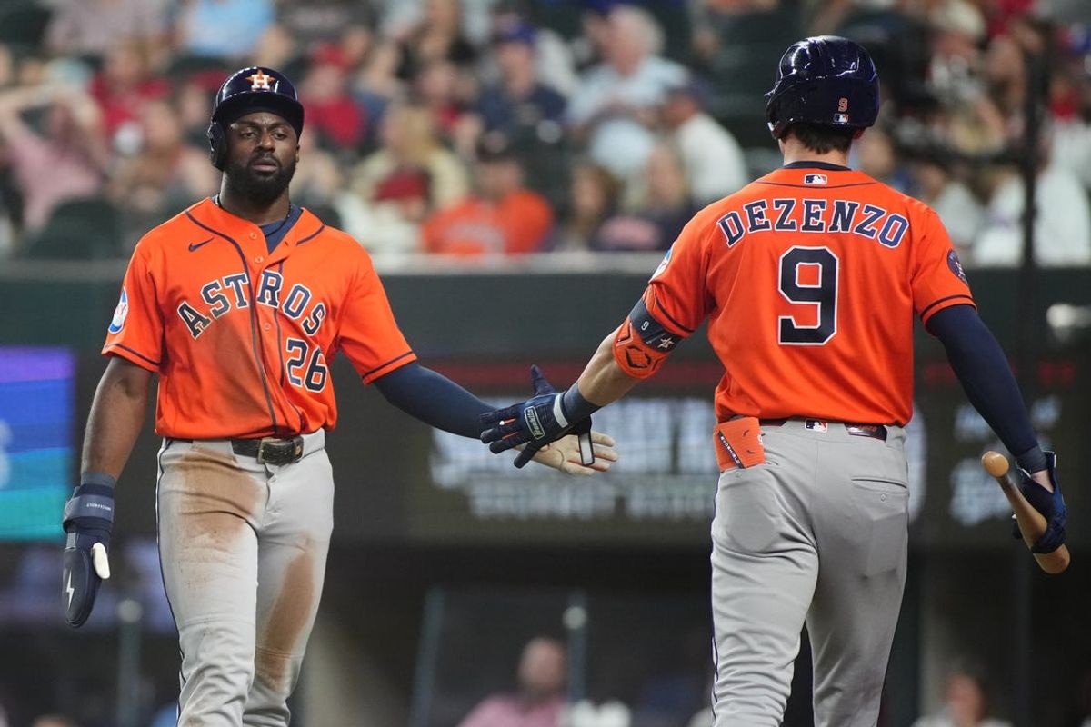 May 28, 2026; Arlington, Texas, USA;  Houston Astros center fielder Taylor Trammell (26) slaps the hand of left fielder Zach Dezenzo (9) after scoring against the Texas Rangers during the third inning at Globe Life Field. Mandatory Credit: Raymond Carlin III-Imagn Images