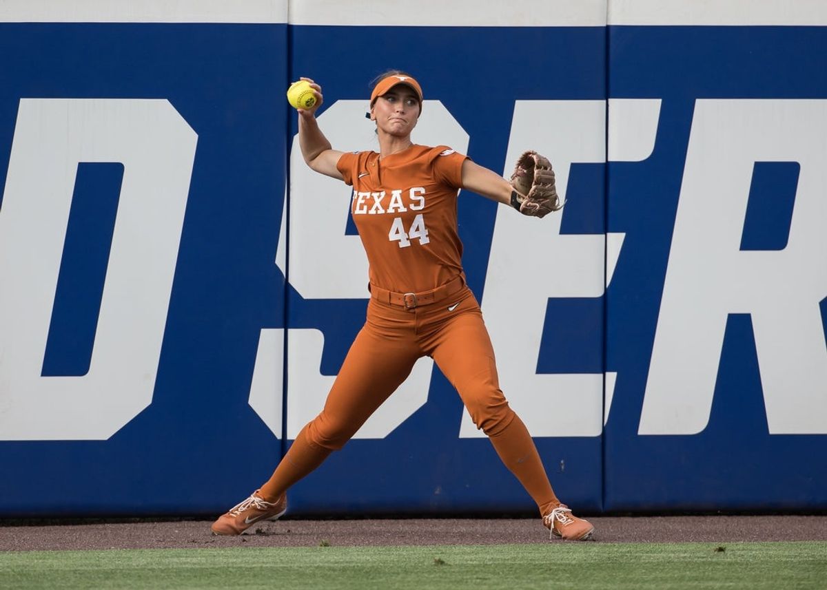 May 29, 2026; Oklahoma City, OK, USA;  Texas Longhorns utility Kaiah Altmeyer (44) throws the ball to second after fielding it off the wall in the first inning against the Mississippi State Bulldogs during the NCAA Women’s College World Series at Devon Park. Mandatory Credit: Brett Rojo-Imagn Images