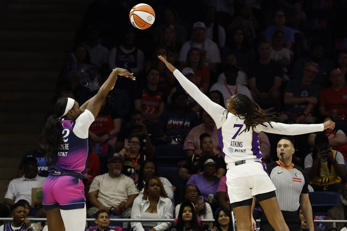 May 29, 2026; Washington, District of Columbia, USA; Washington Mystics forward Michaela Onyenwere (12) shoots the ball over Los Angeles Sparks guard Ariel Atkins (7) in the first half at CareFirst Arena. Mandatory Credit: Geoff Burke-Imagn Images