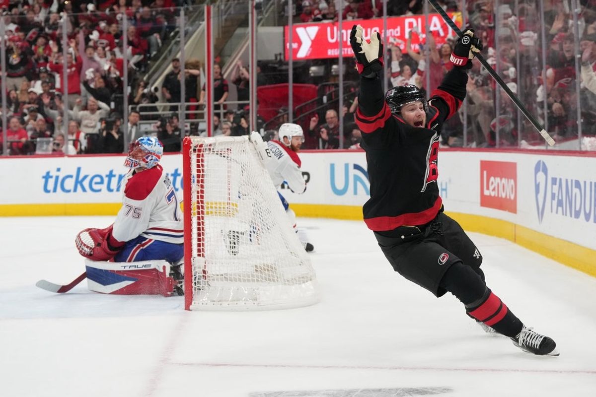 May 29, 2026; Raleigh, North Carolina, USA; Carolina Hurricanes left wing Eric Robinson (50) reacts after scoring an even strength goal against Montreal Canadiens goaltender Jakub Dobes (75) in game five of the Eastern Conference Final of the 2026 Stanley Cup Playoffs during the first period during the first period at Lenovo Center. Mandatory Credit: James Guillory-Imagn Images