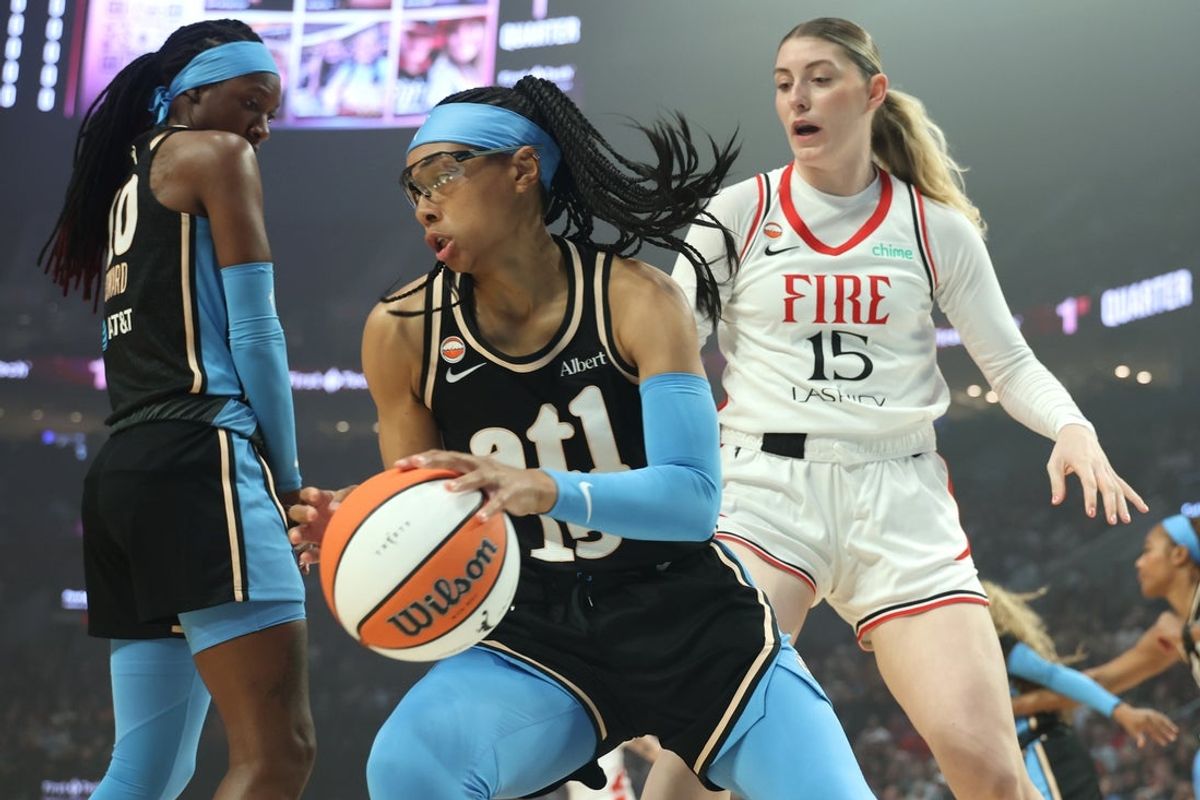May 29, 2026; Portland, Oregon, USA;  Atlanta Dream guard Allisha Gray (15) grabs a rebound against Portland Fire center Luisa Geiselsoder (15) during the first half at Moda Center. Mandatory Credit: Jaime Valdez-Imagn Images