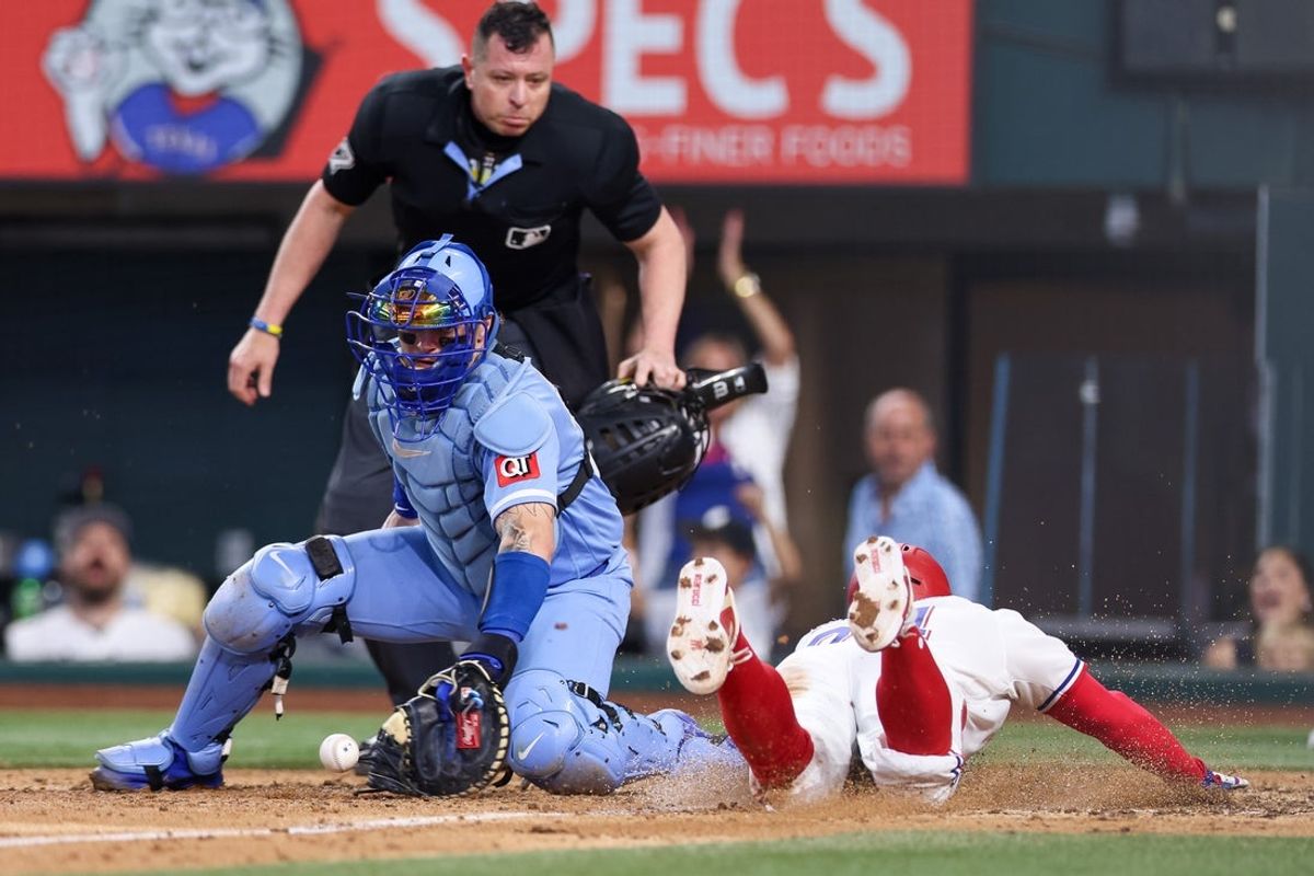 May 30, 2026; Arlington, Texas, USA; Texas Rangers right fielder Brandon Nimmo (24) slides in under the tag of Kansas City Royals catcher Carter Jensen (22) for the winning run during the ninth inning at Globe Life Field. Mandatory Credit: Andrew Dieb-Imagn Images
