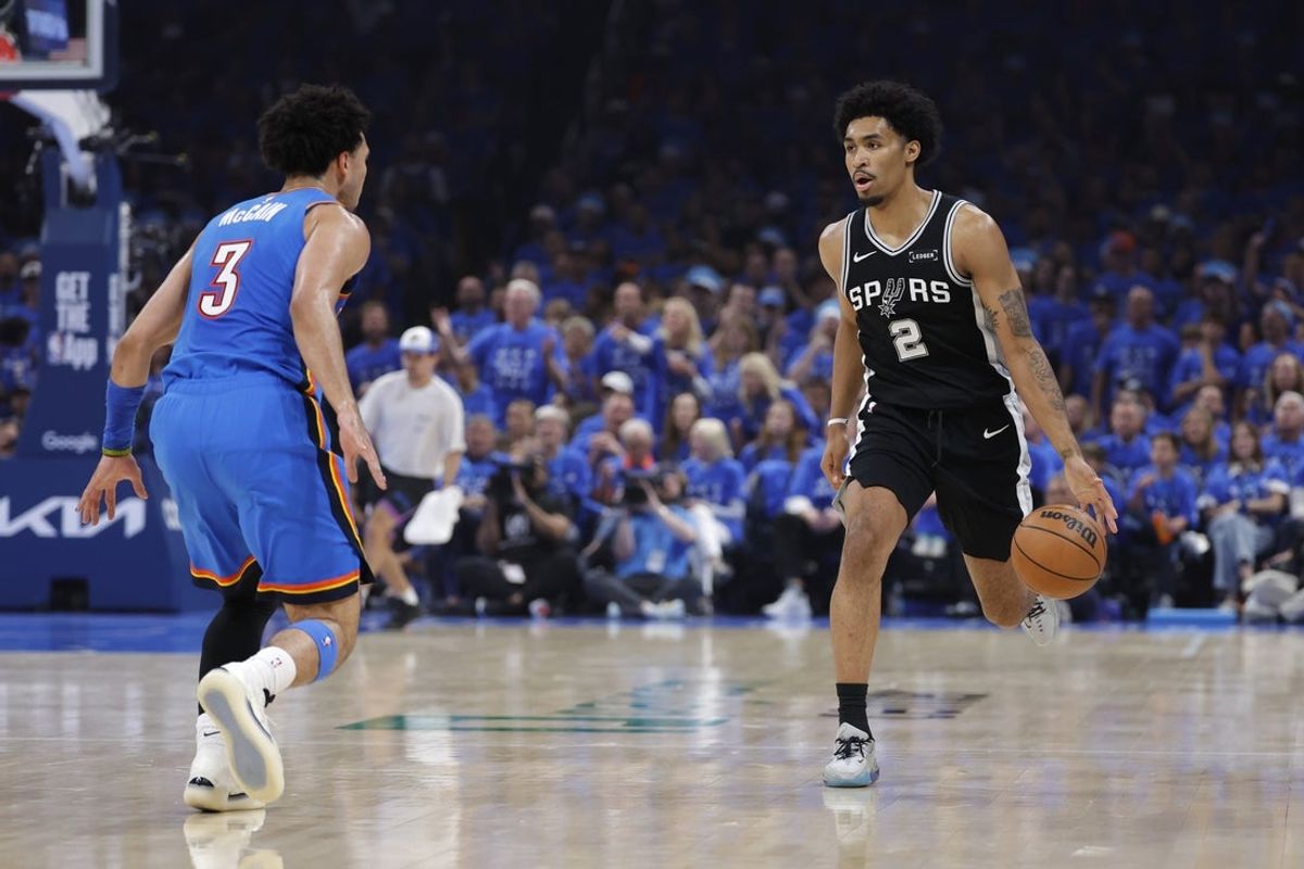 May 30, 2026; Oklahoma City, Oklahoma, USA; San Antonio Spurs guard Dylan Harper (2) controls the ball against Oklahoma City Thunder guard Jared McCain (3) in the second quarter during game seven of the western conference finals for the 2026 NBA playoffs at Paycom Center. Mandatory Credit: Alonzo Adams-Imagn Images