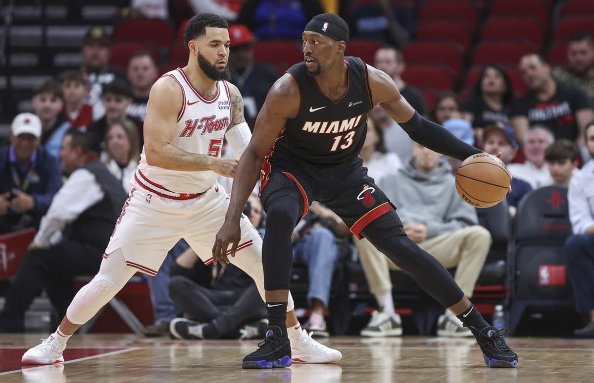 Apr 5, 2024; Houston, Texas, USA; Miami Heat center Bam Adebayo (13) controls the ball as Houston Rockets guard Fred VanVleet (5) defends during the first quarter at Toyota Center.