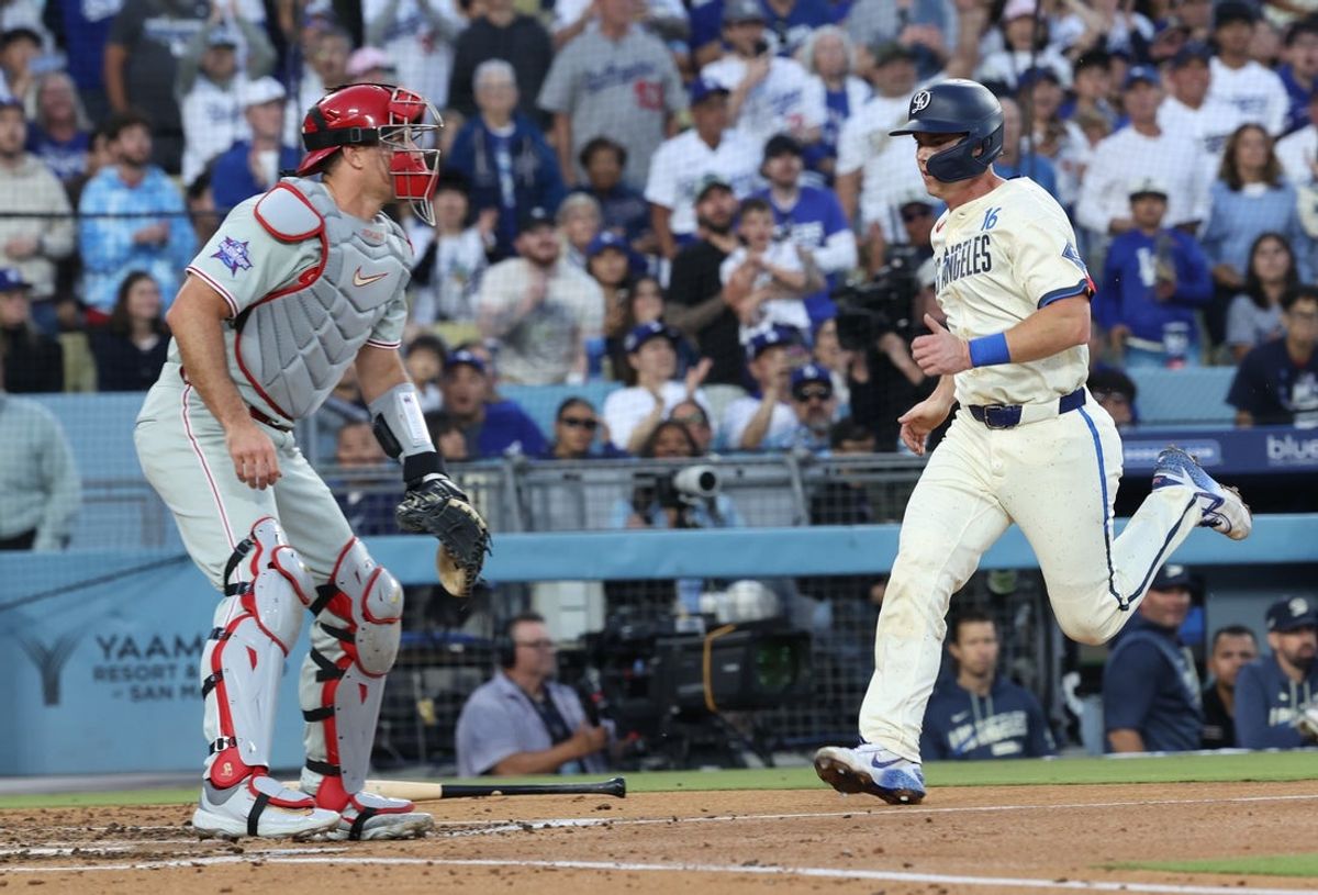 May 30, 2026; Los Angeles, California, USA; Los Angeles Dodgers catcher Will Smith (16) scores past Philadelphia Phillies catcher J.T. Realmuto (10) during the second inning at Dodger Stadium. Mandatory Credit: Kiyoshi Mio-Imagn Images
