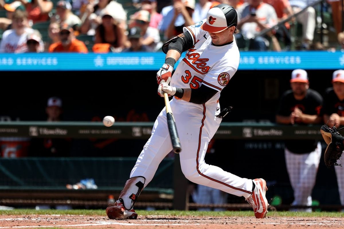 May 31, 2026; Baltimore, Maryland, USA; Baltimore Orioles designated hitter Adley Rutschman (35) hits a sacrifice fly to score a run during the sixth inning against the Toronto Blue Jays at Oriole Park at Camden Yards. Mandatory Credit: Daniel Kucin Jr.-Imagn Images