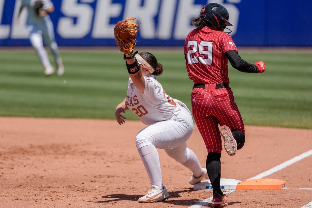 Texas utility Katie Stewart (20) forces out Nebraska utility Samantha Bland (29) at first base in the second inning during a softball game at the Women’s College World Series between Texas and Nebraska at Devon Park in Oklahoma City, on Sunday, May 31, 2026.