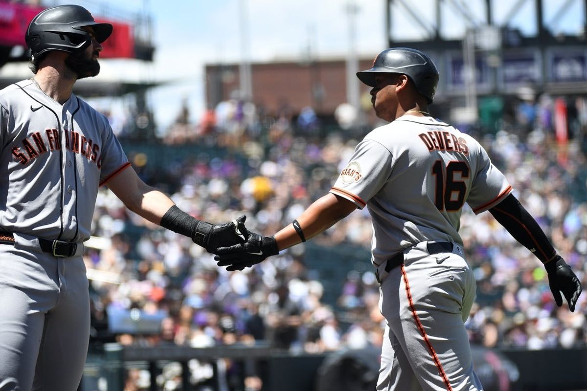May 31, 2026; Denver, Colorado, USA; San Francisco Giants infielder Rafael Devers (16) is congratulated by designated hitter Bryce Eldridge (8) after scoring in the first inning against the Colorado Rockies at Coors Field. Mandatory Credit: Christopher Hanewinckel-Imagn Images