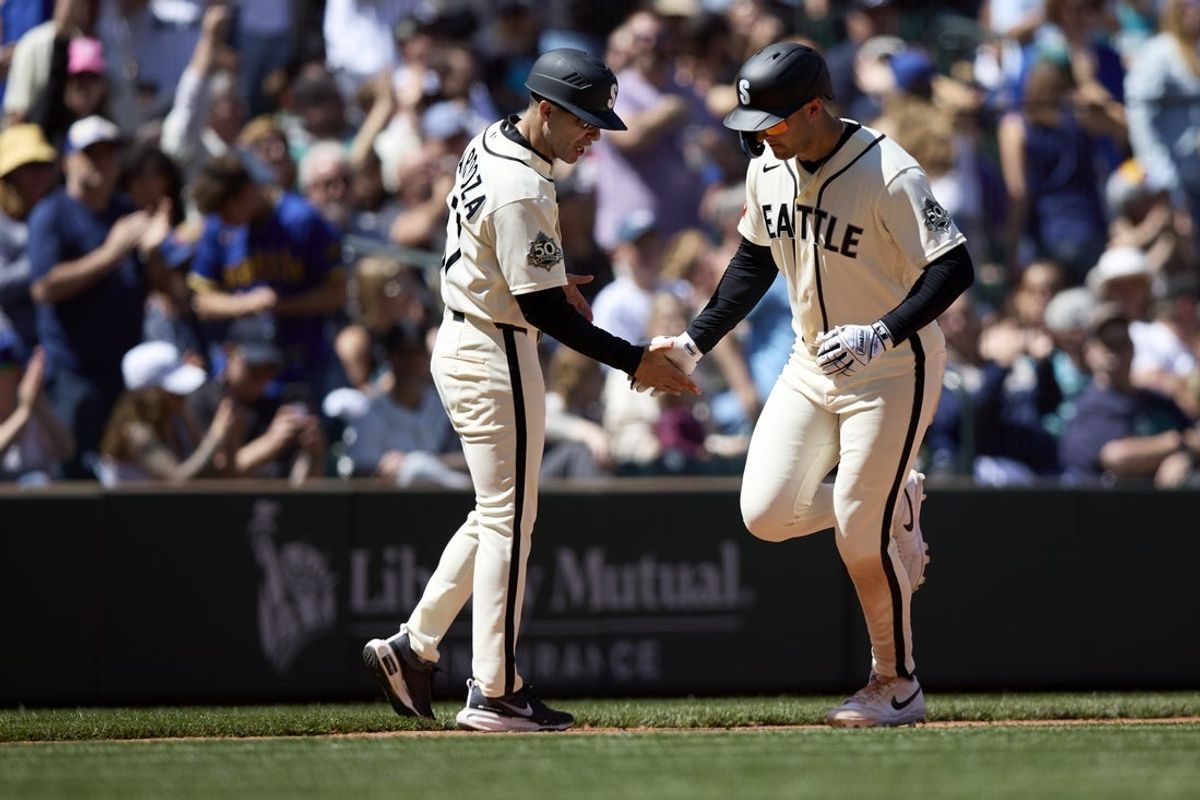May 31, 2026; Seattle, Washington, USA; Seattle Mariners designated hitter Dominic Canzone (8) is greeted by third base coach Carlos Cardoza (57) on his solo home run against the Arizona Diamondbacks during the sixth inning at T-Mobile Park. Mandatory Credit: John Froschauer-Imagn Images