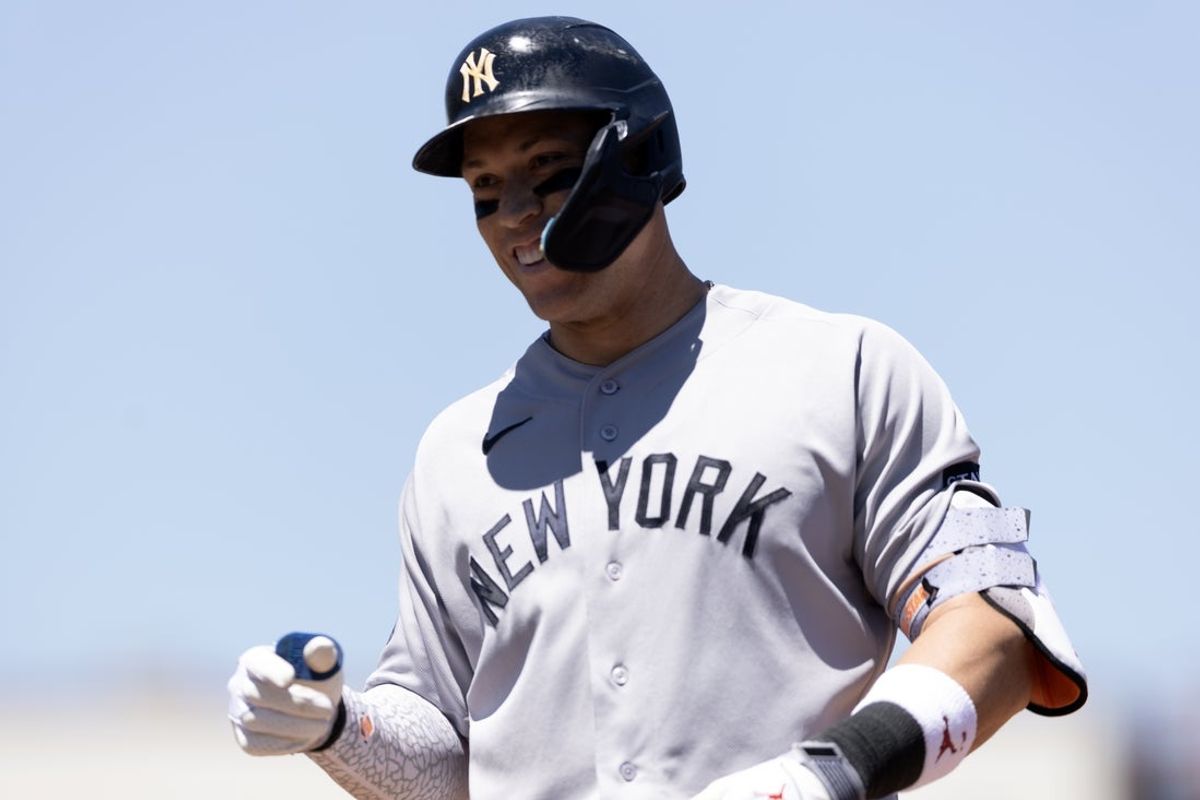 May 31, 2026; West Sacramento, California, USA; New York Yankees right fielder Aaron Judge (99) smiles back at his teammates after his bloop hit fell between two Athletics fielders during the third inning at Sutter Health Park. Mandatory Credit: D. Ross Cameron-Imagn Images