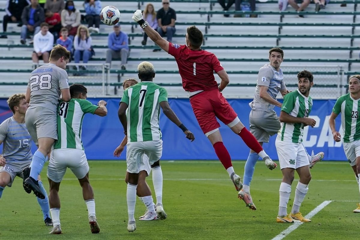 May 14, 2021; Cary, North Carolina, USA; Marshall goalkeeper Oliver Semmle (1) gets a block against North Carolina.