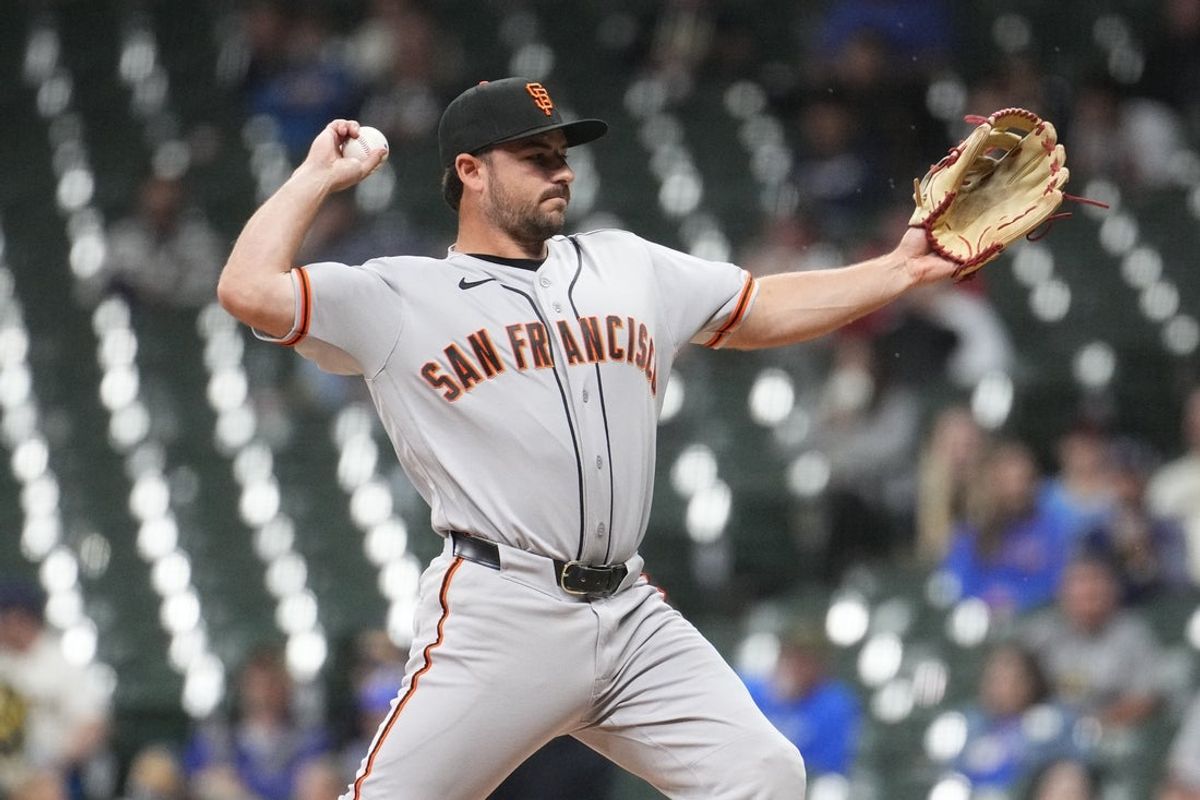 Jun 1, 2026; Milwaukee, Wisconsin, USA; San Francisco Giants infielder Buddy Kennedy delivers a pitch against the Milwaukee Brewers in the eighth inning at American Family Field. Mandatory Credit: Michael McLoone-Imagn Images