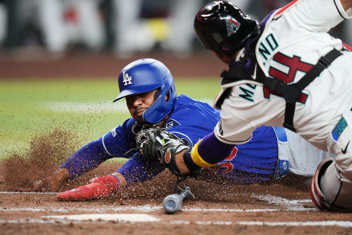 Arizona Diamondbacks catcher Gabriel Moreno (14) tags out Los Angeles Dodgers base runner Mookie Betts (50) at home plate during their game at Chase Field in Phoenix on June 1, 2026.