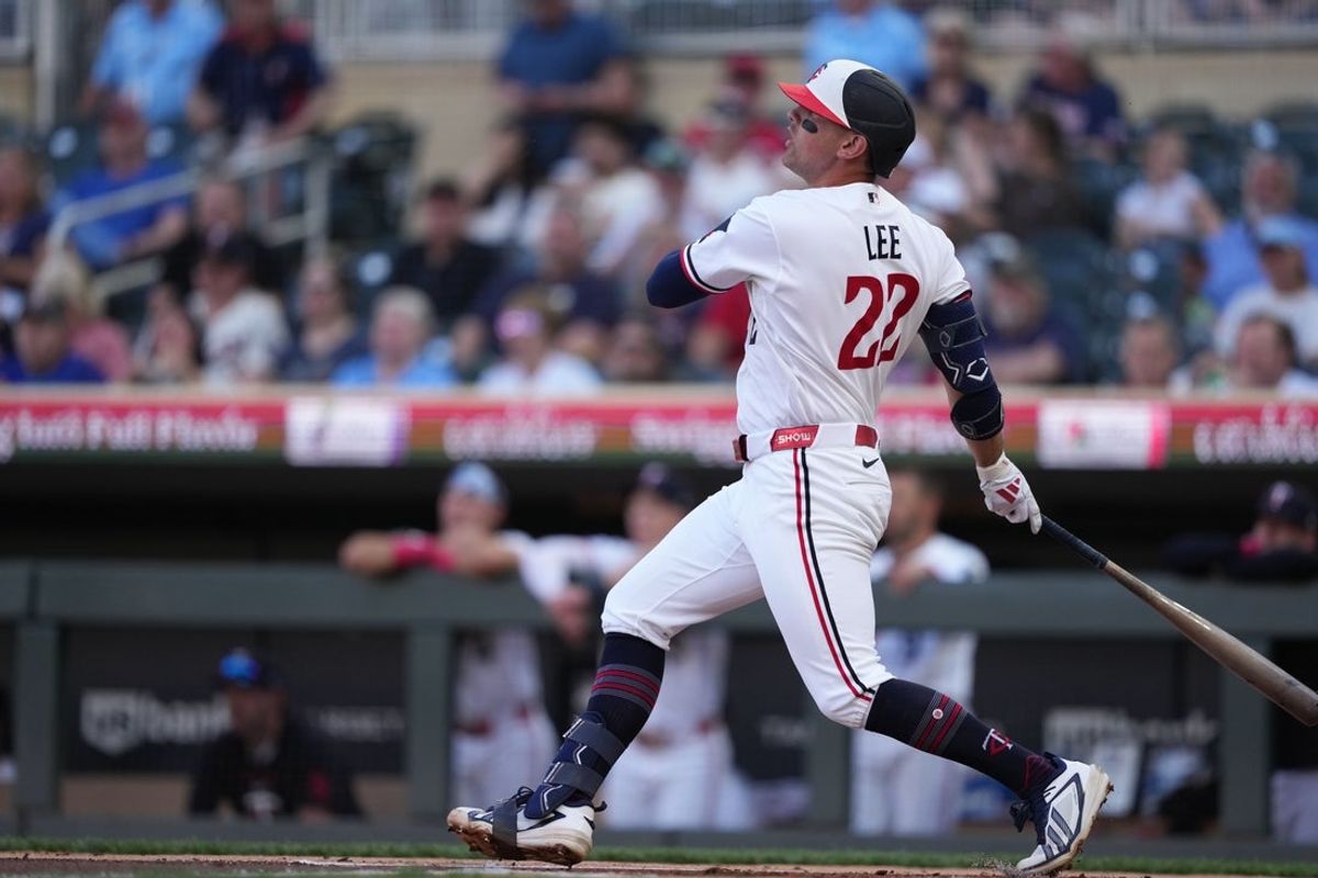 Jun 2, 2026; Minneapolis, Minnesota, USA; Minnesota Twins third baseman Brooks Lee (22) hits a single during the first inning against the Chicago White Sox at Target Field. Mandatory Credit: Jordan Johnson-Imagn Images